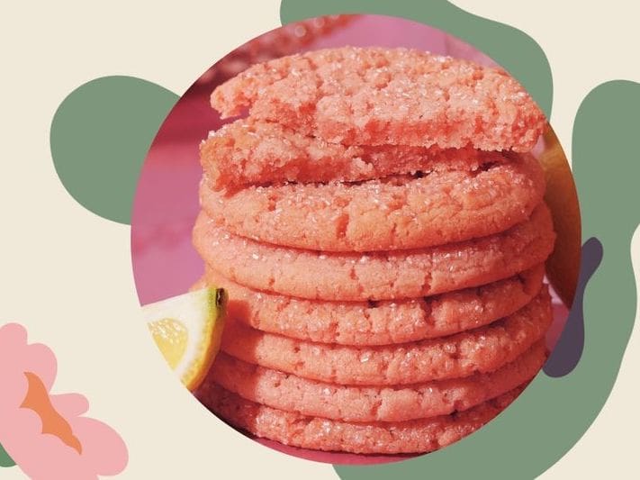 An image of pink sugar cookies is displayed on top of illistrations of lettuce and flowers.